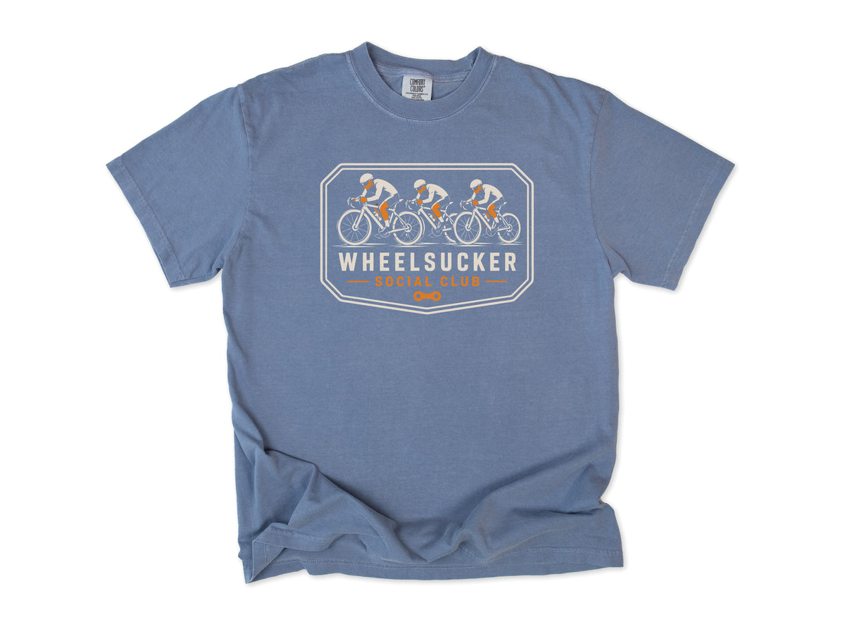 Funny cycling T-shirt in Blue Jean, Wheelsucker: three cyclists in a paceline on an orange and cream badge, 'Social Club', for road cyclists