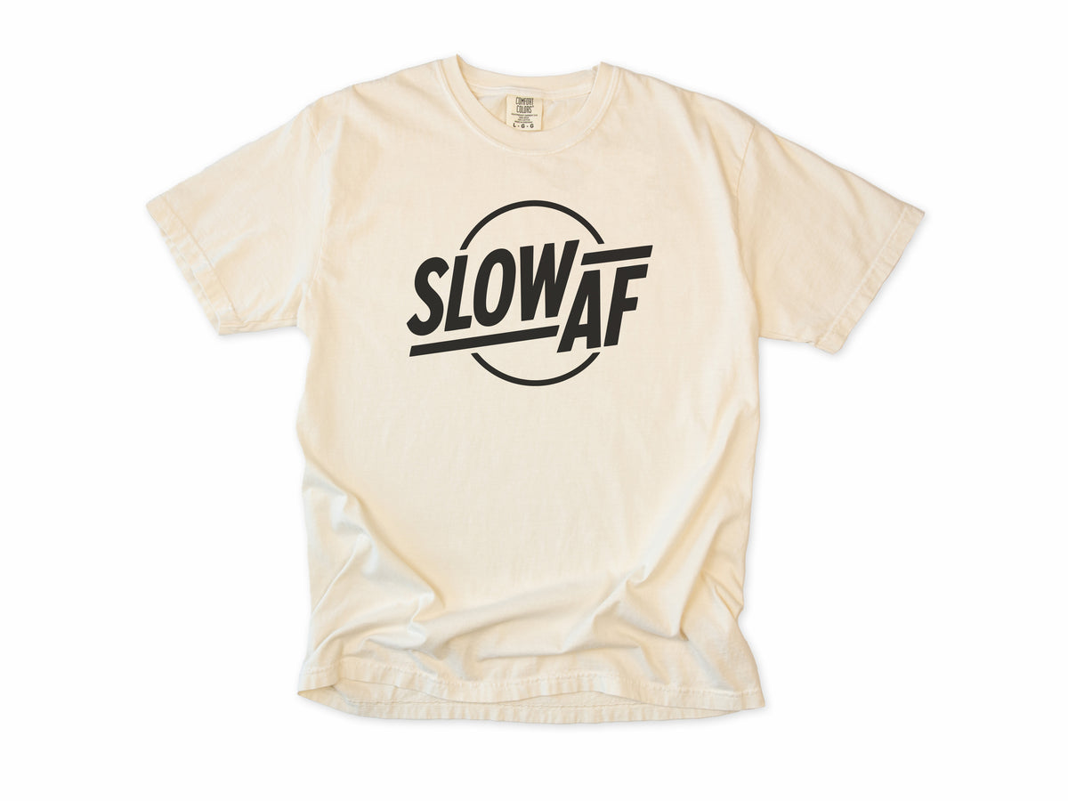 Funny cycling T-shirt in Ivory, 'Slow AF' in bold letters inside a circle, for relaxed riders
