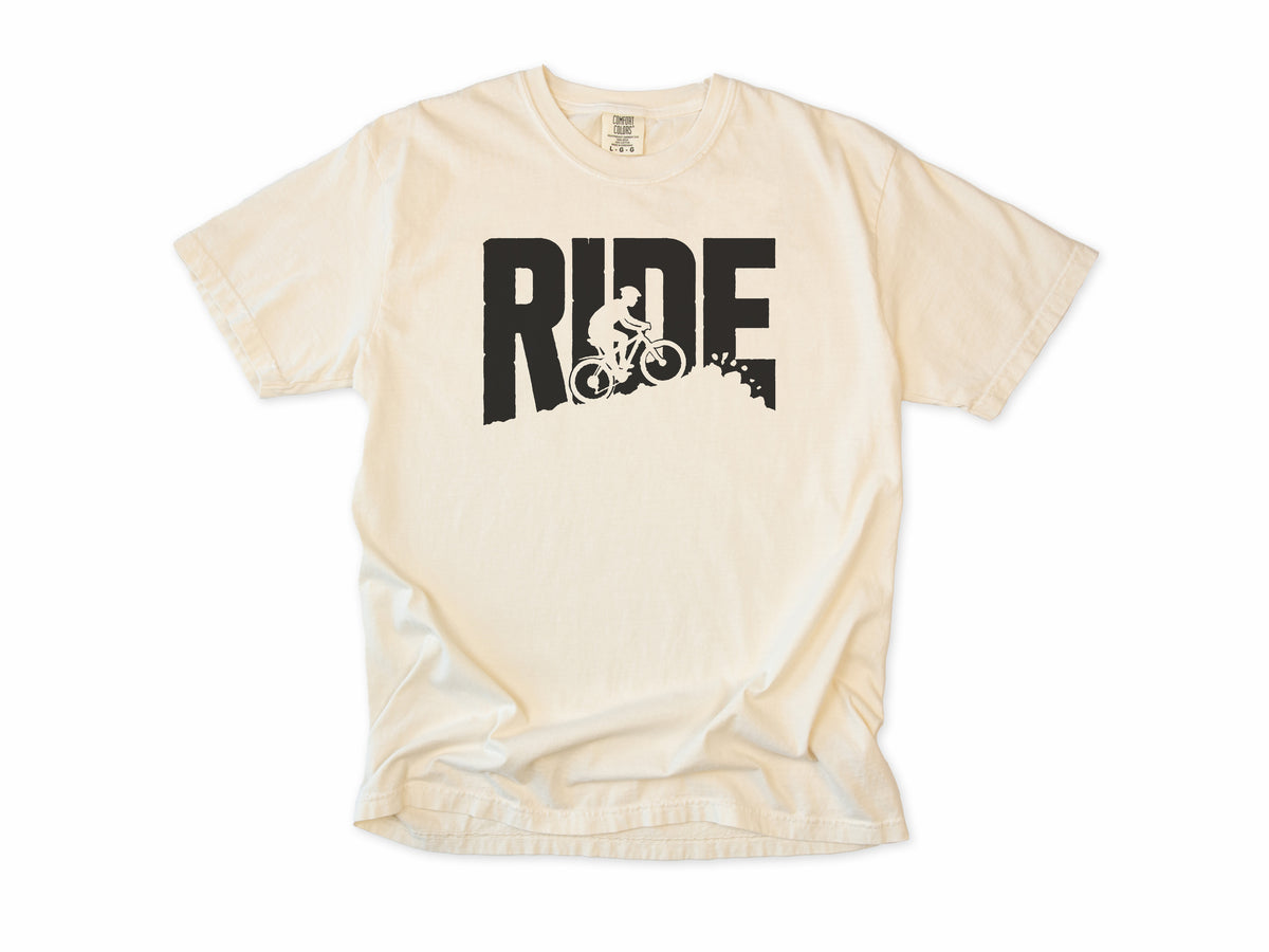 Cycling T-shirt in Ivory, bold 'RIDE' letters with a mountain biker on a slope, for mountain bikers