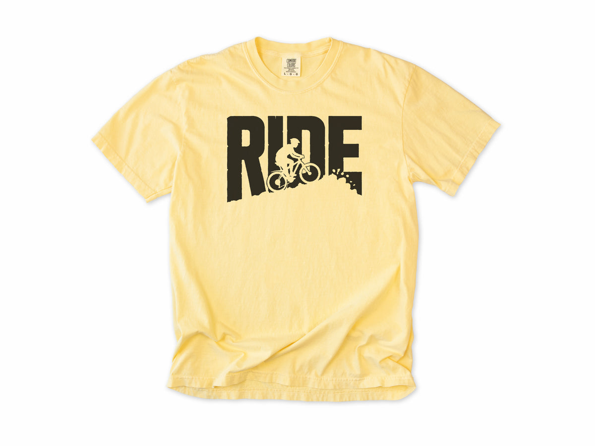 Cycling T-shirt in Butter, bold 'RIDE' letters with a mountain biker on a slope, for mountain bikers