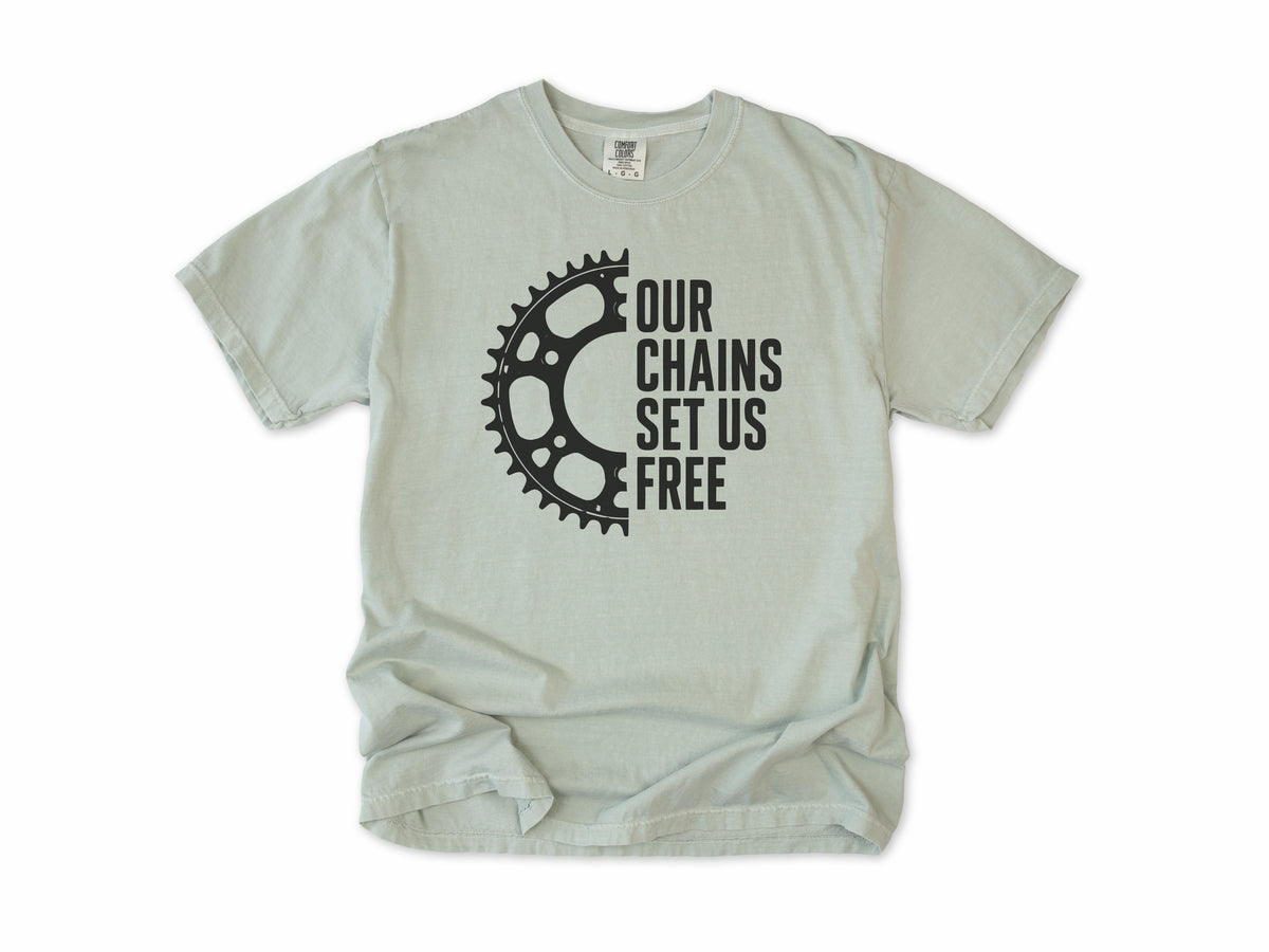 Funny cycling T-shirt in Bay, 'Our Chains Set Us Free' beside a chainring, for cyclists