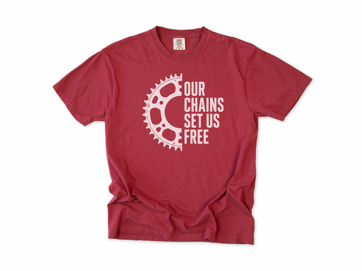 Funny cycling T-shirt in Chili, 'Our Chains Set Us Free' beside a chainring, for cyclists