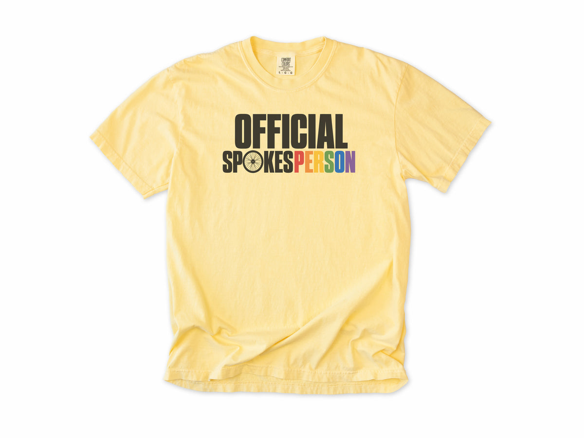 Funny cycling T-shirt in Butter, 'Official Spokesperson' with a wheel and rainbow lettering, for cyclists and allies