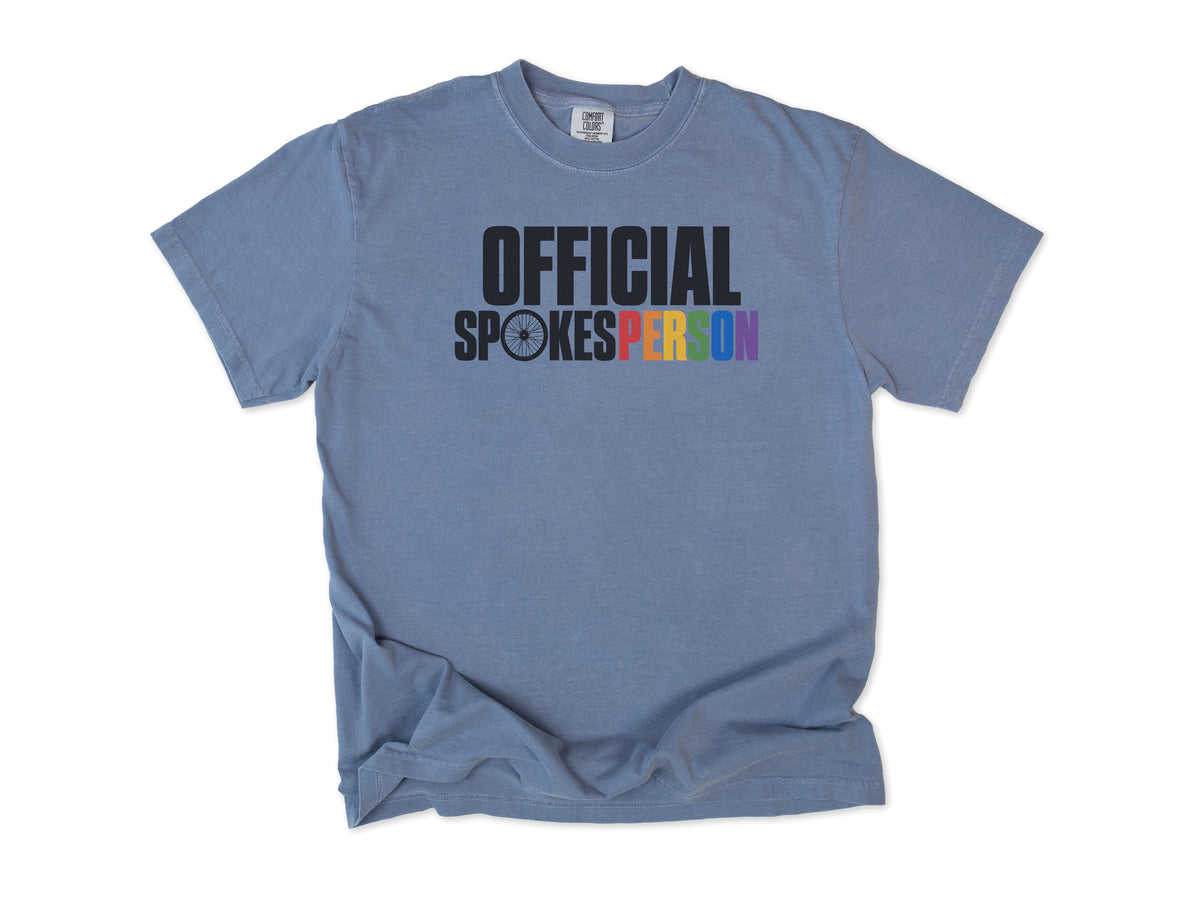 Funny cycling T-shirt in Blue Jean, 'Official Spokesperson' with a wheel and rainbow lettering, for cyclists and allies