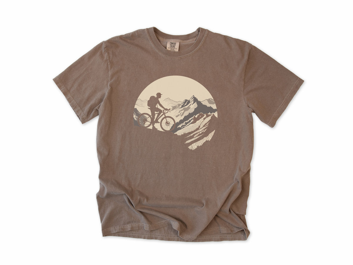 Cycling T-shirt in Espresso, a mountain biker climbing a rocky peak, in a circle, for mountain bikers