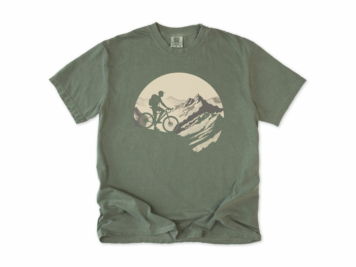 Cycling T-shirt in Moss, a mountain biker climbing a rocky peak, in a circle, for mountain bikers