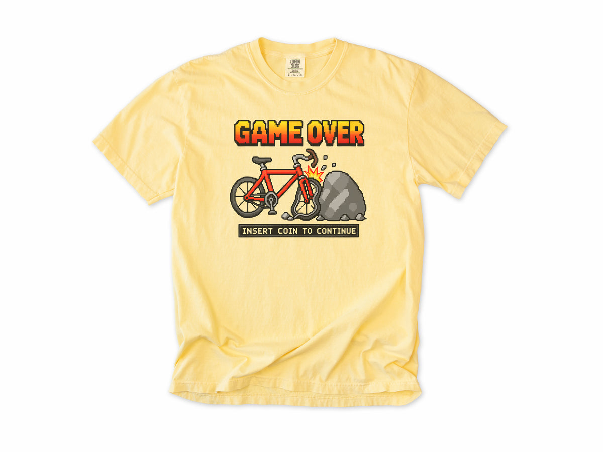 Funny cycling T-shirt in Butter, 'Game Over, Insert Coin to Continue', a crashed bike, for cyclists who game