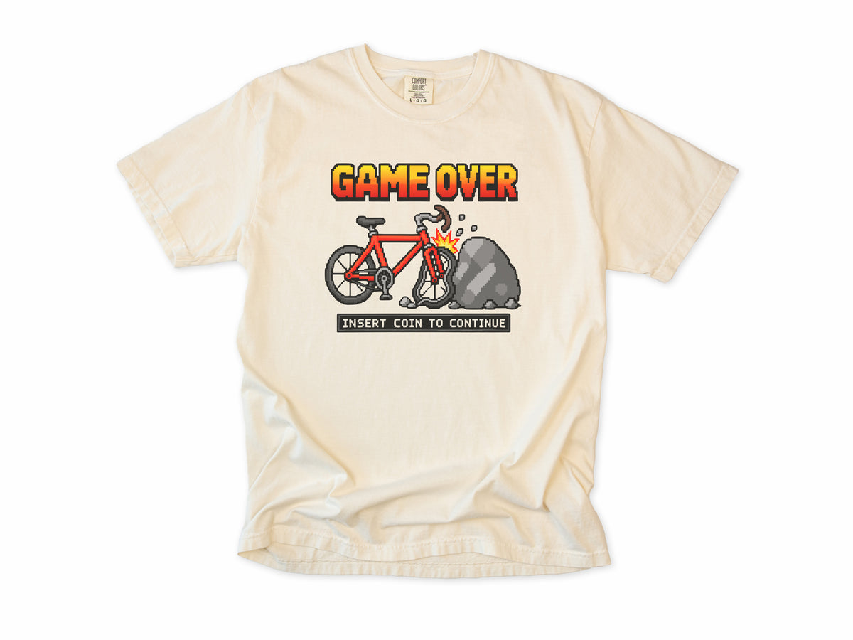 Funny cycling T-shirt in Ivory, 'Game Over, Insert Coin to Continue', a crashed bike, for cyclists who game