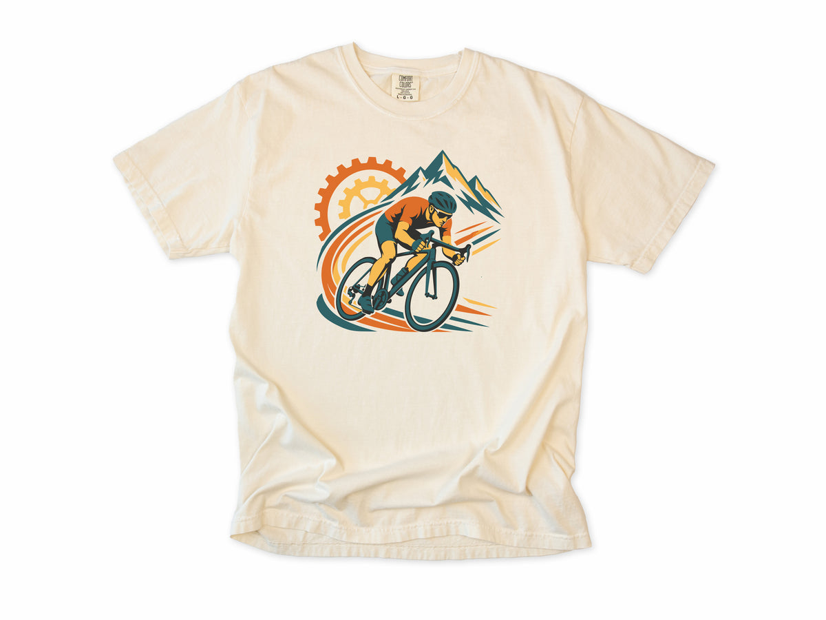 Cycling T-shirt in Ivory, a cyclist before a chainring and mountains with orange swooshes, for road cyclists