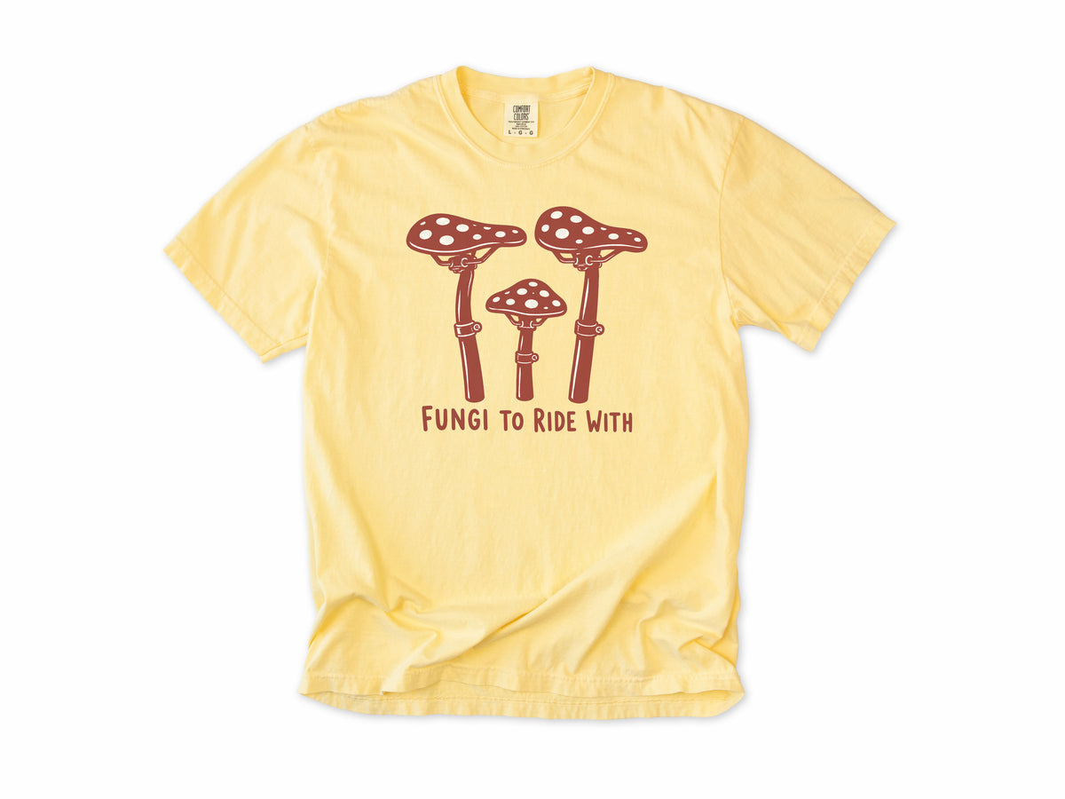 Funny cycling T-shirt in Butter, three red toadstools with handlebar stems, 'Fungi to Ride With', for mountain bikers