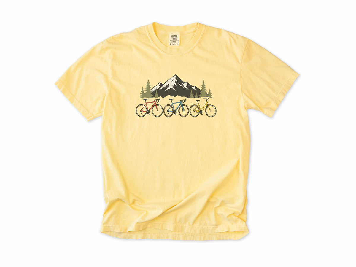 Cycling T-shirt in Butter, three bikes in front of a snowy mountain, for road and mountain bikers
