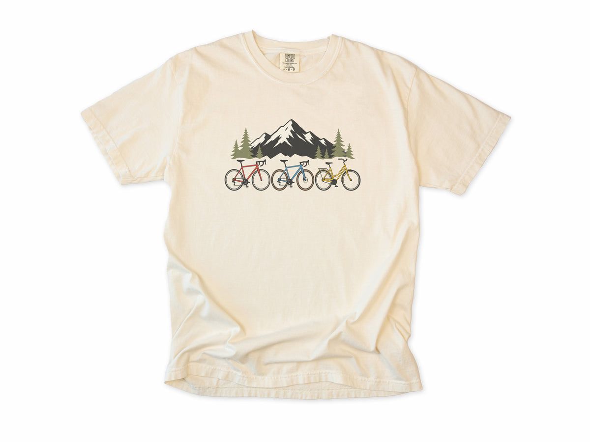 Cycling T-shirt in Ivory, three bikes in front of a snowy mountain, for road and mountain bikers