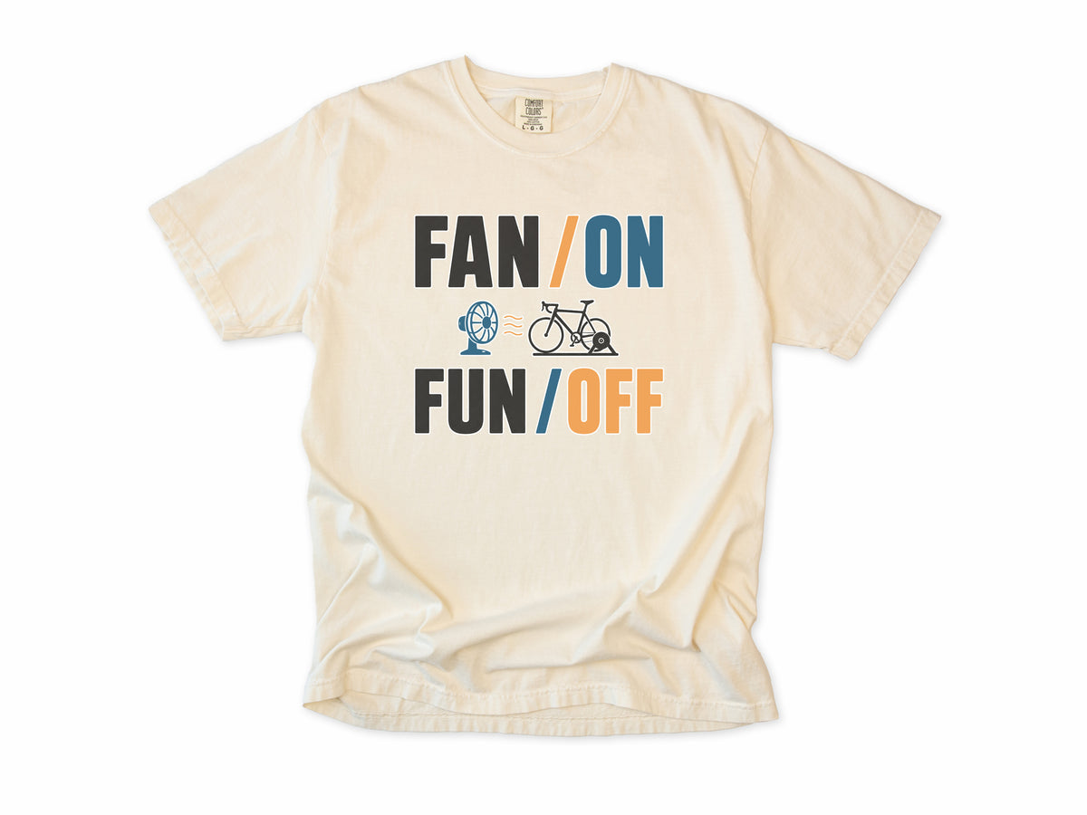 Funny cycling T-shirt in Ivory, 'Fan On, Fun Off' with a bike on an indoor trainer and a fan, for indoor trainer riders