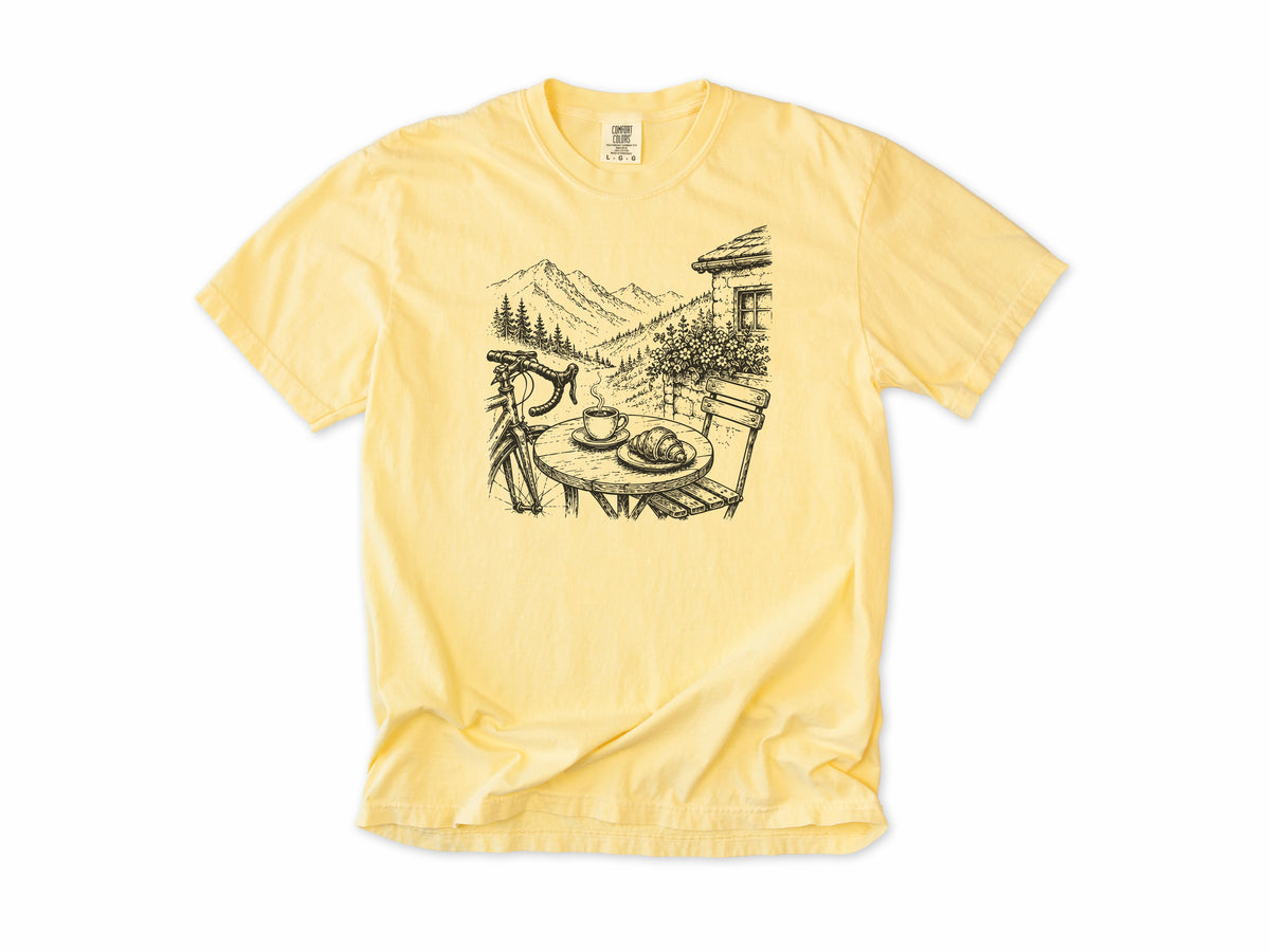 Cycling T-shirt in Butter, a sketch of a cafe table with coffee above an alpine valley, for cafe stop riders