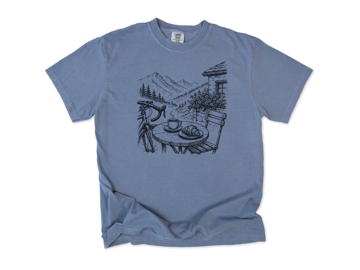 Cycling T-shirt in Blue Jean, a sketch of a cafe table with coffee above an alpine valley, for cafe stop riders