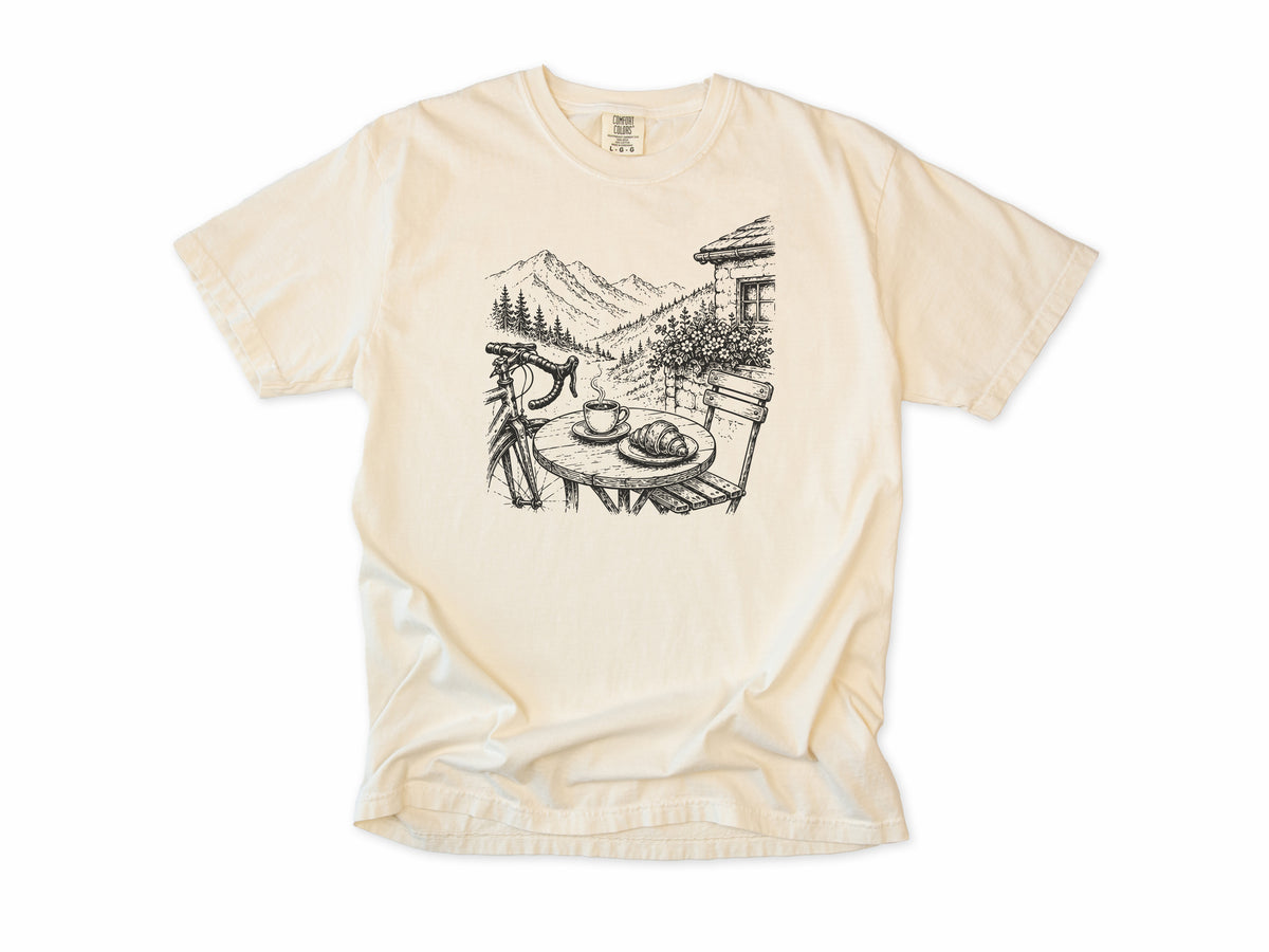 Cycling T-shirt in Ivory, a sketch of a cafe table with coffee above an alpine valley, for cafe stop riders
