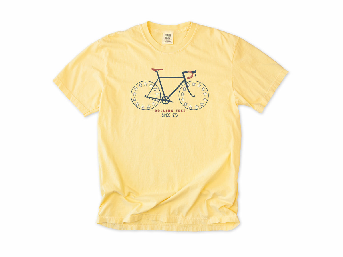 Cycling T-shirt in Butter, Betsy Ross Bike: a road bike with star wheels, 'Rolling Free', America 250 and 4th of July gift for cyclists