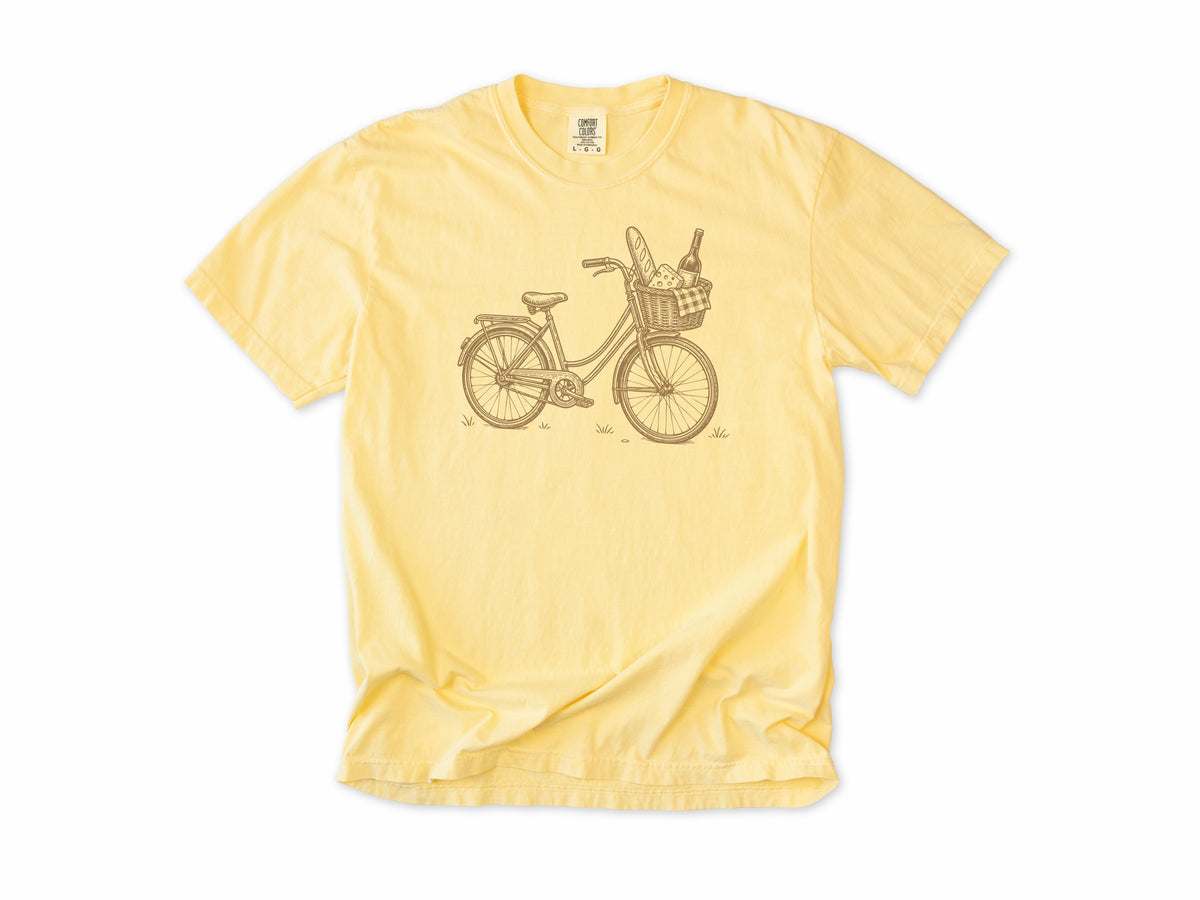Cycling T-shirt in Butter, a vintage bike with a baguette and wine in its basket, for city and cafe cyclists