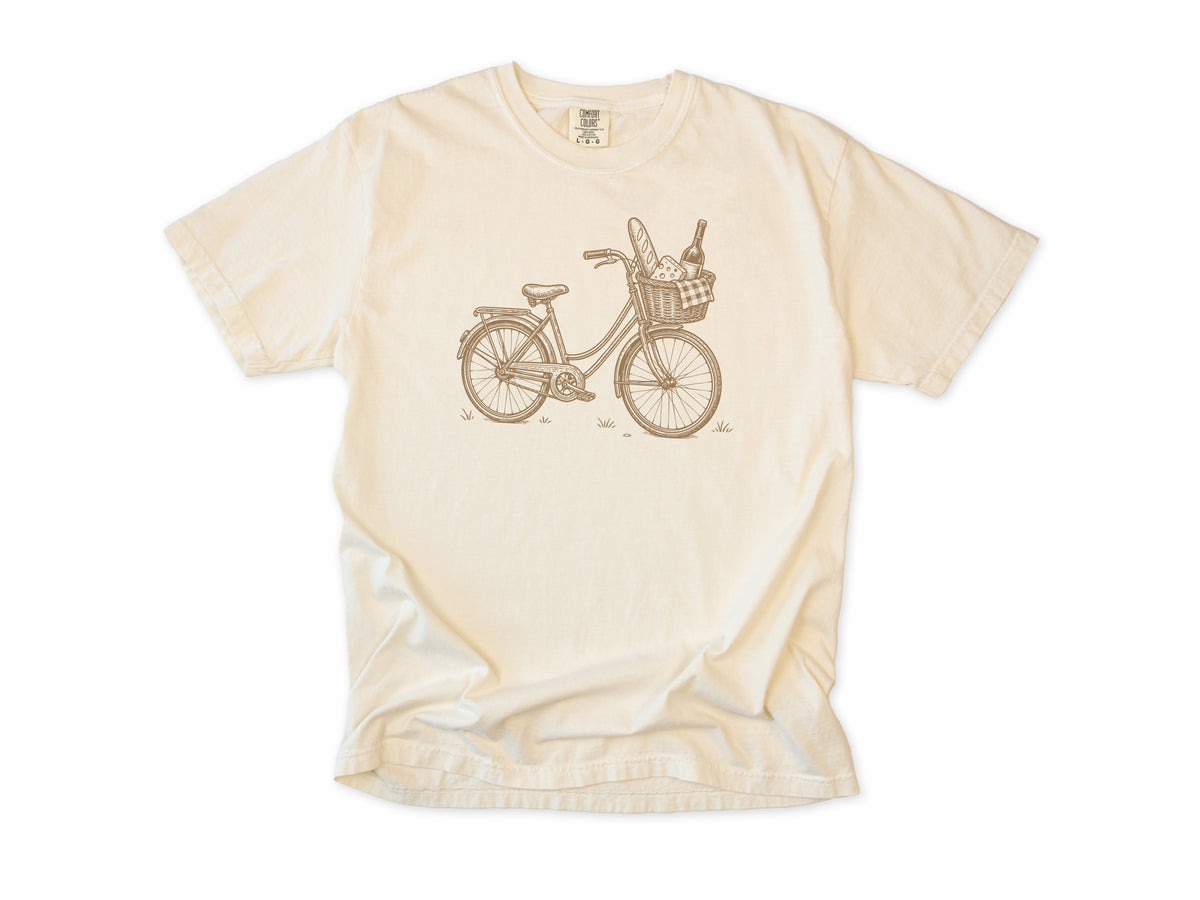 Cycling T-shirt in Ivory, a vintage bike with a baguette and wine in its basket, for city and cafe cyclists