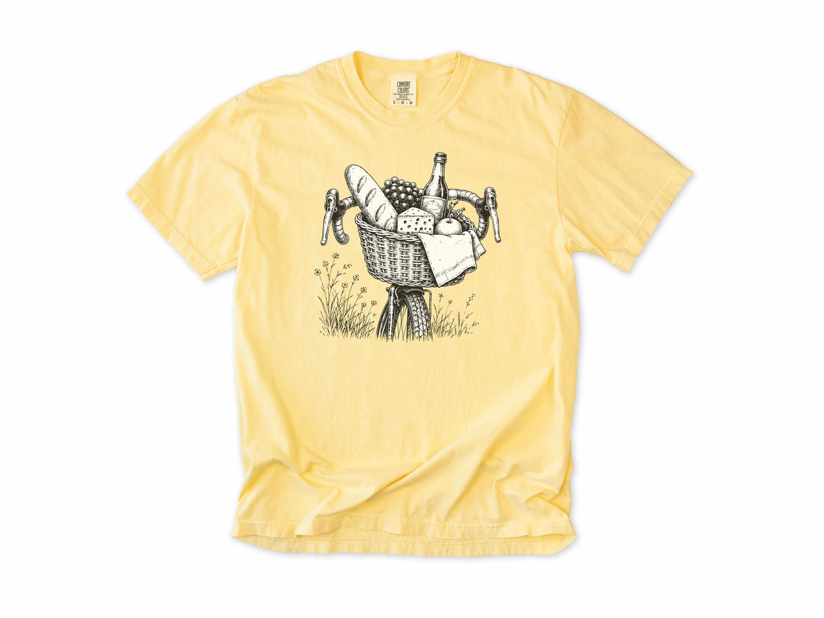 Cycling T-shirt in Butter, a bike basket with a baguette, cheese and wine, line drawing, for leisure and cafe cyclists