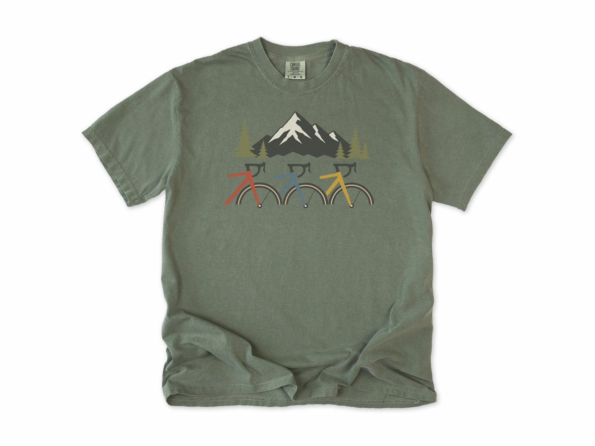 Cycling T-shirt in Moss, three cropped bikes under a snowy mountain, for road and mountain bikers