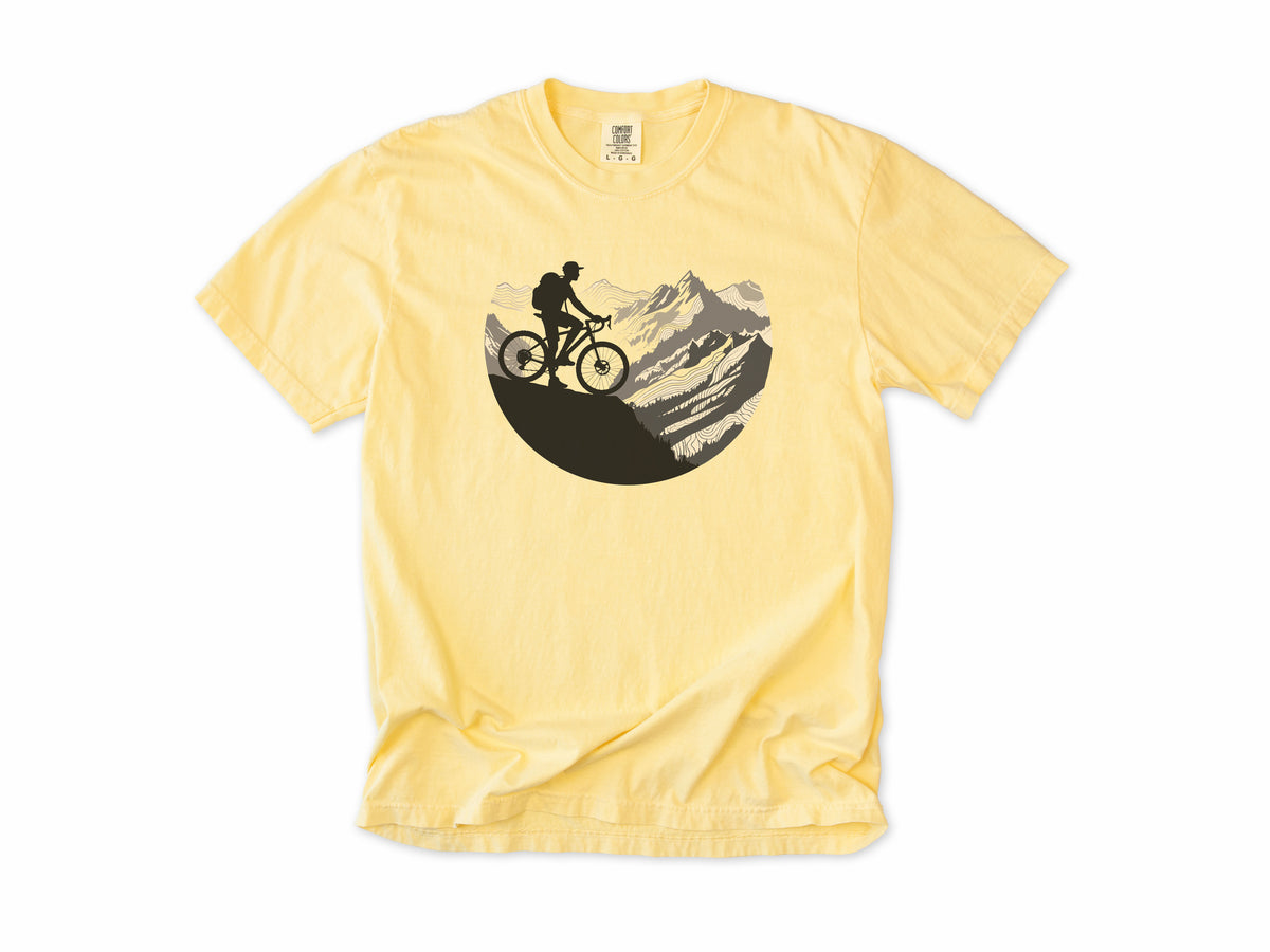 Cycling T-shirt in Butter, Cycling Mountain: a mountain biker riding up a rocky mountain, in a circle, for mountain bikers