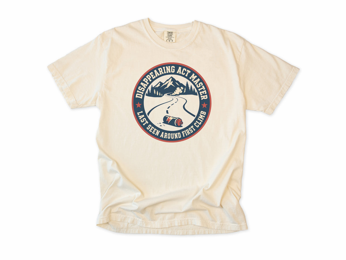 Funny cycling T-shirt in Ivory, 'Disappearing Act Master', a mountain road and bottle, for riders who get dropped