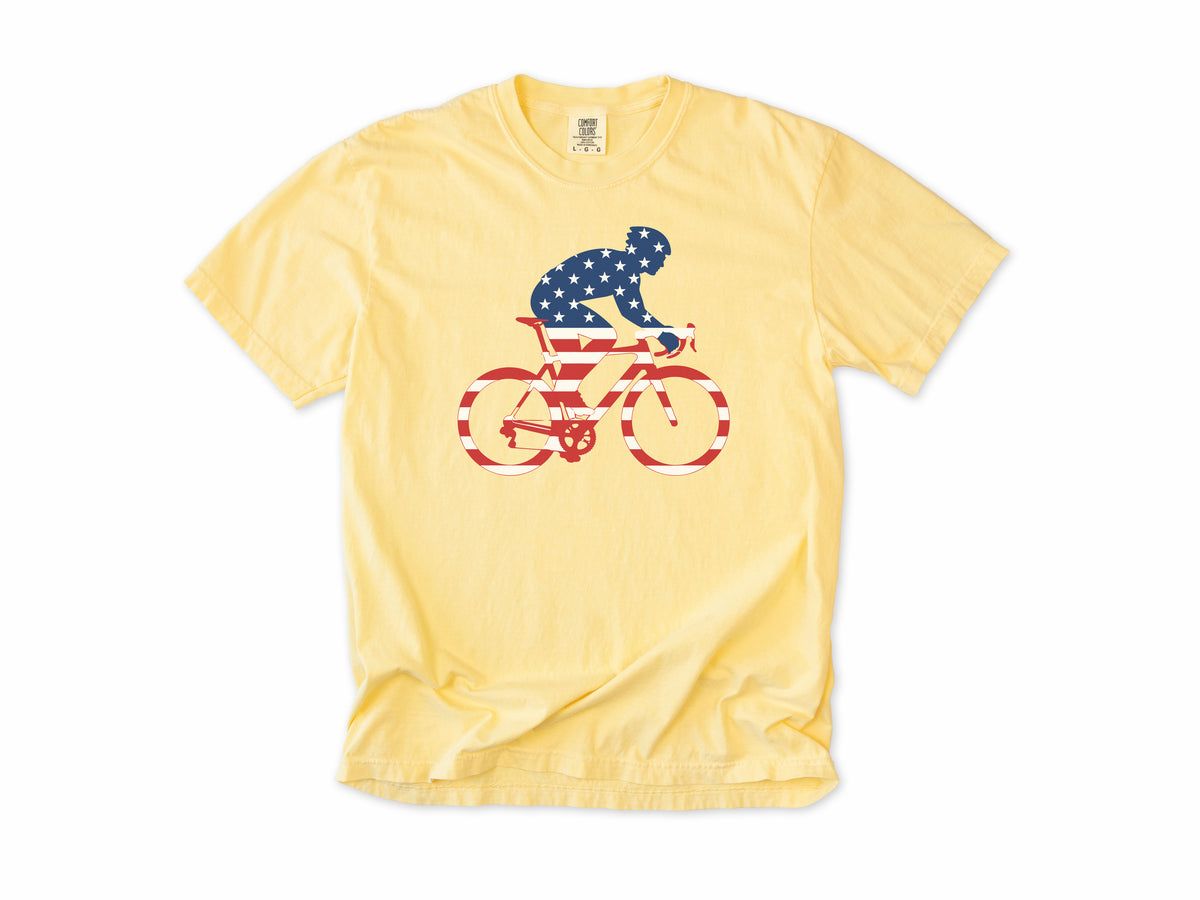 Cycling T-shirt in Butter, a rider and bike filled with US flag stars and stripes, 4th of July gift for cyclists
