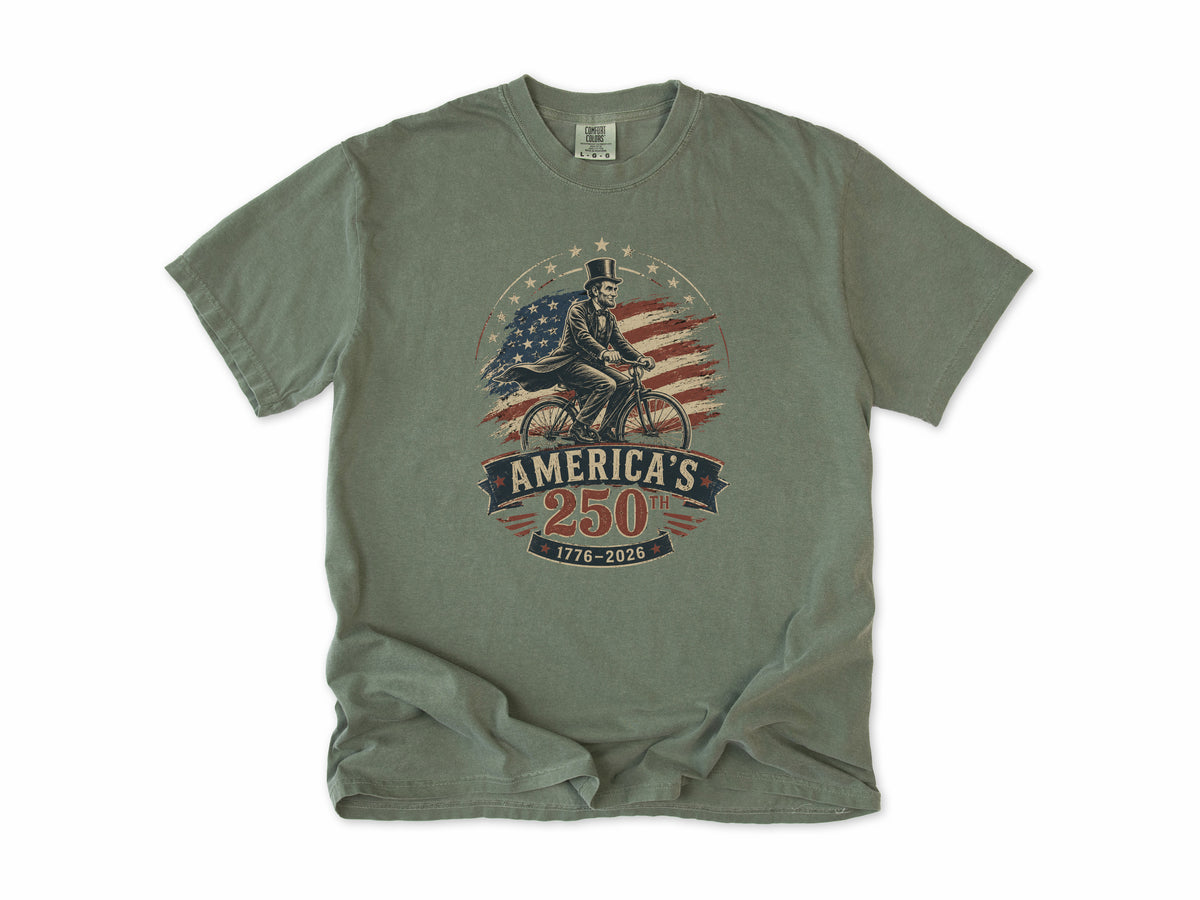 Cycling T-shirt in Moss, Abe Lincoln Bike: Abraham Lincoln riding a bike before the US flag, America 250 and 4th of July gift for cyclists
