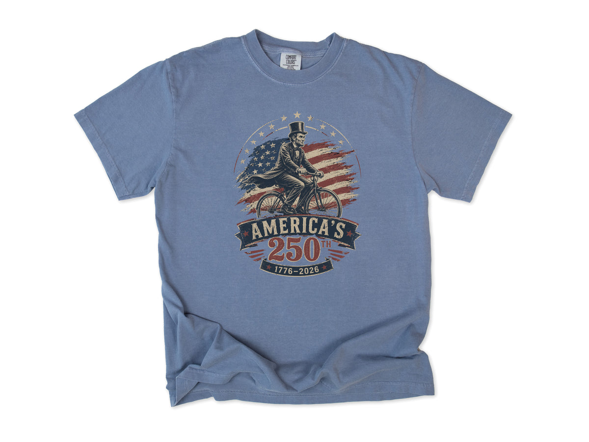 Cycling T-shirt in Blue Jean, Abe Lincoln Bike: Abraham Lincoln riding a bike before the US flag, America 250 and 4th of July gift for cyclists