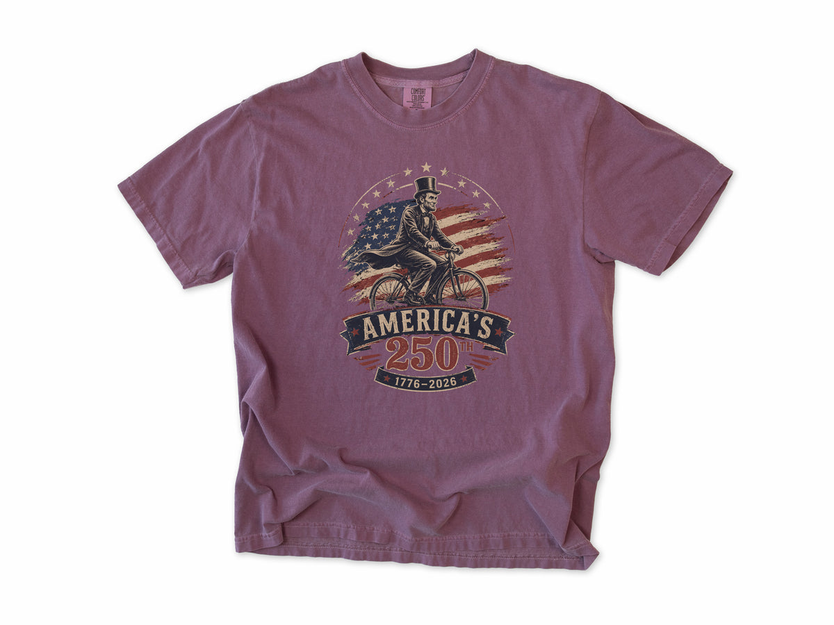 Cycling T-shirt in Berry, Abe Lincoln Bike: Abraham Lincoln riding a bike before the US flag, America 250 and 4th of July gift for cyclists