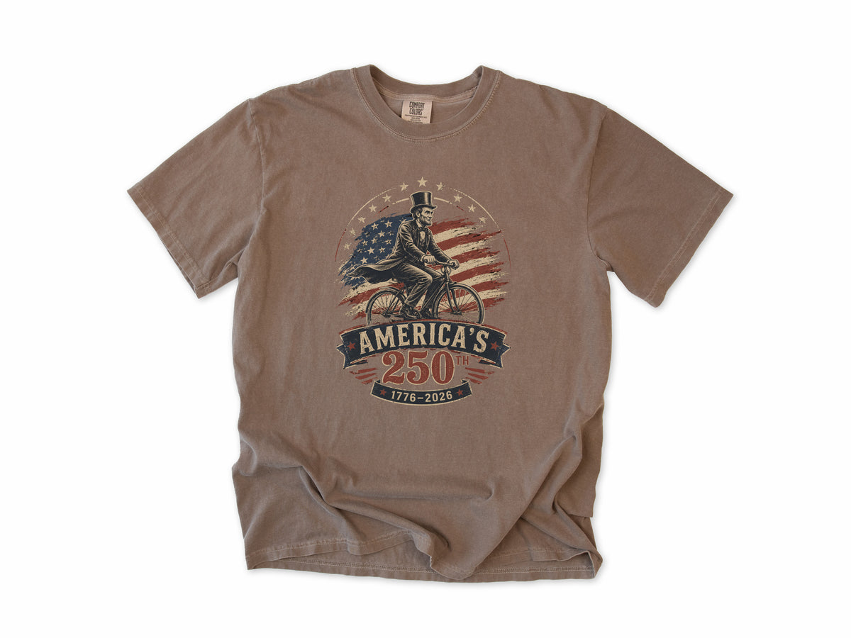 Cycling T-shirt in Espresso, Abe Lincoln Bike: Abraham Lincoln riding a bike before the US flag, America 250 and 4th of July gift for cyclists