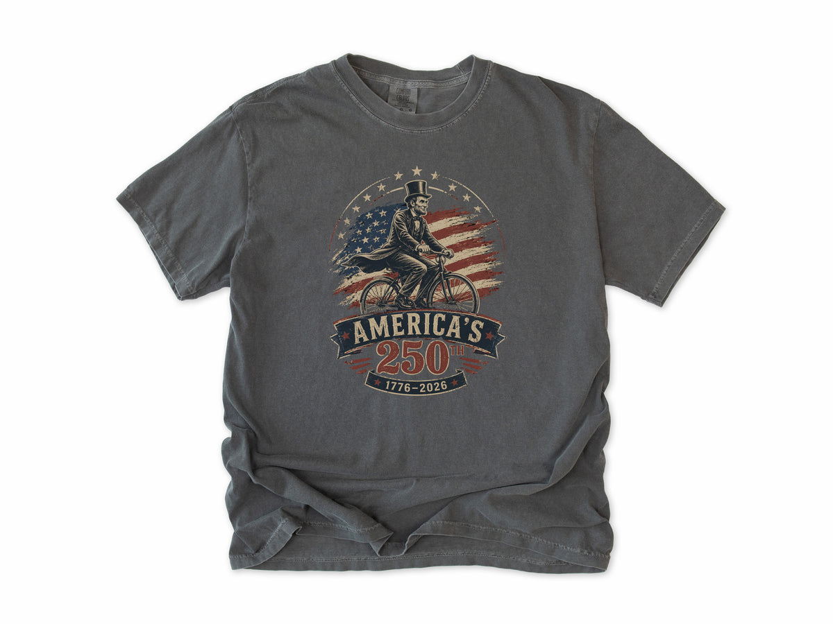 Cycling T-shirt in Pepper, Abe Lincoln Bike: Abraham Lincoln riding a bike before the US flag, America 250 and 4th of July gift for cyclists