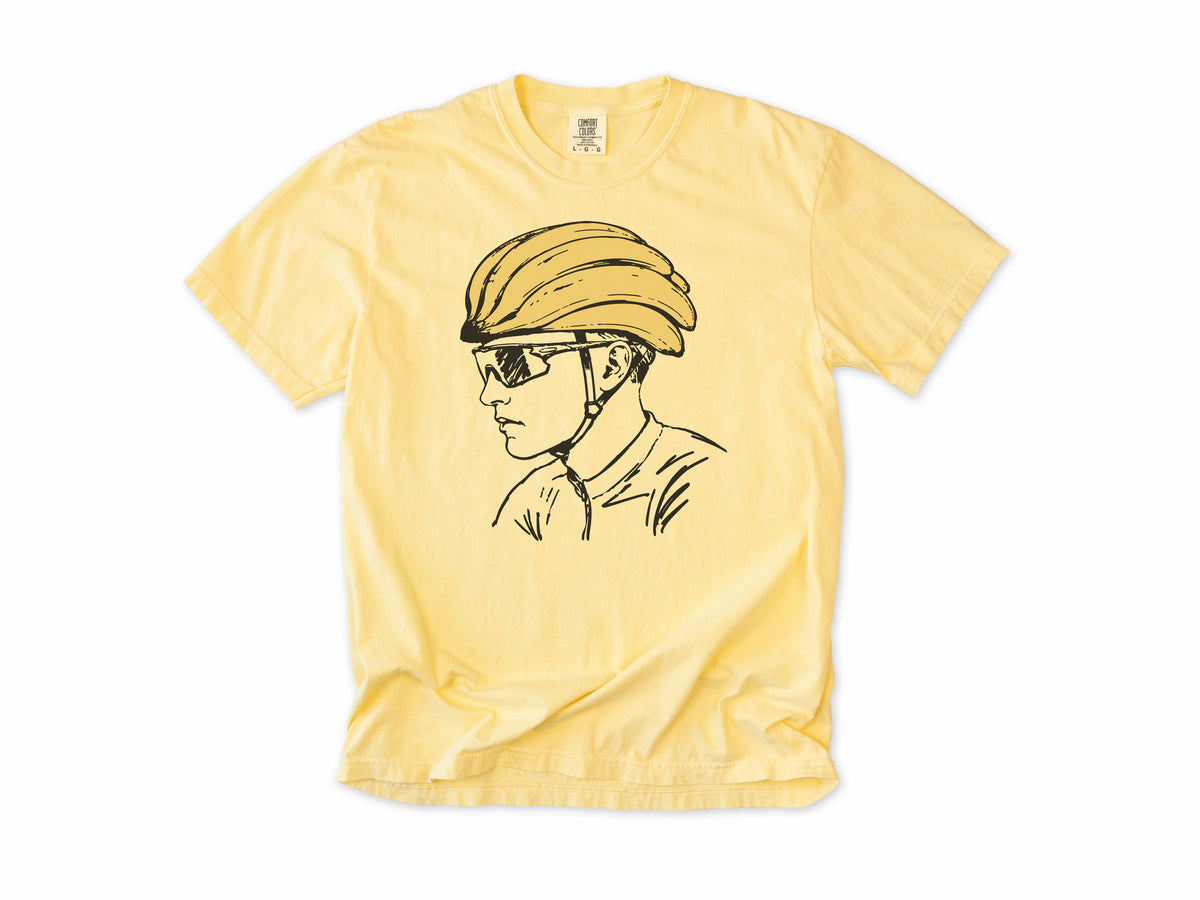 Funny cycling T-shirt in Butter, a line drawing of a cyclist in sunglasses and a banana helmet, for road cyclists