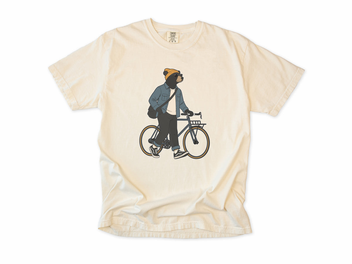 Funny cycling T-shirt in Ivory, Casual Bear: a bear in a beanie and denim jacket walking a city bike, for relaxed everyday riders