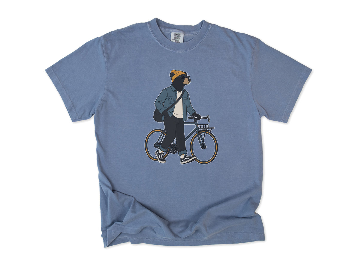 Funny cycling T-shirt in Blue Jean, Casual Bear: a bear in a beanie and denim jacket walking a city bike, for relaxed everyday riders