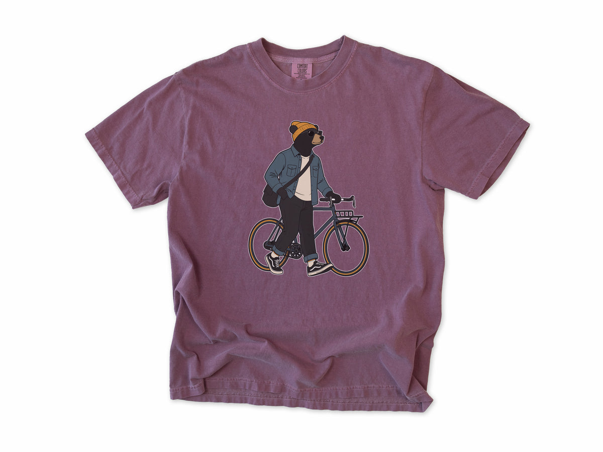 Funny cycling T-shirt in Berry, Casual Bear: a bear in a beanie and denim jacket walking a city bike, for relaxed everyday riders