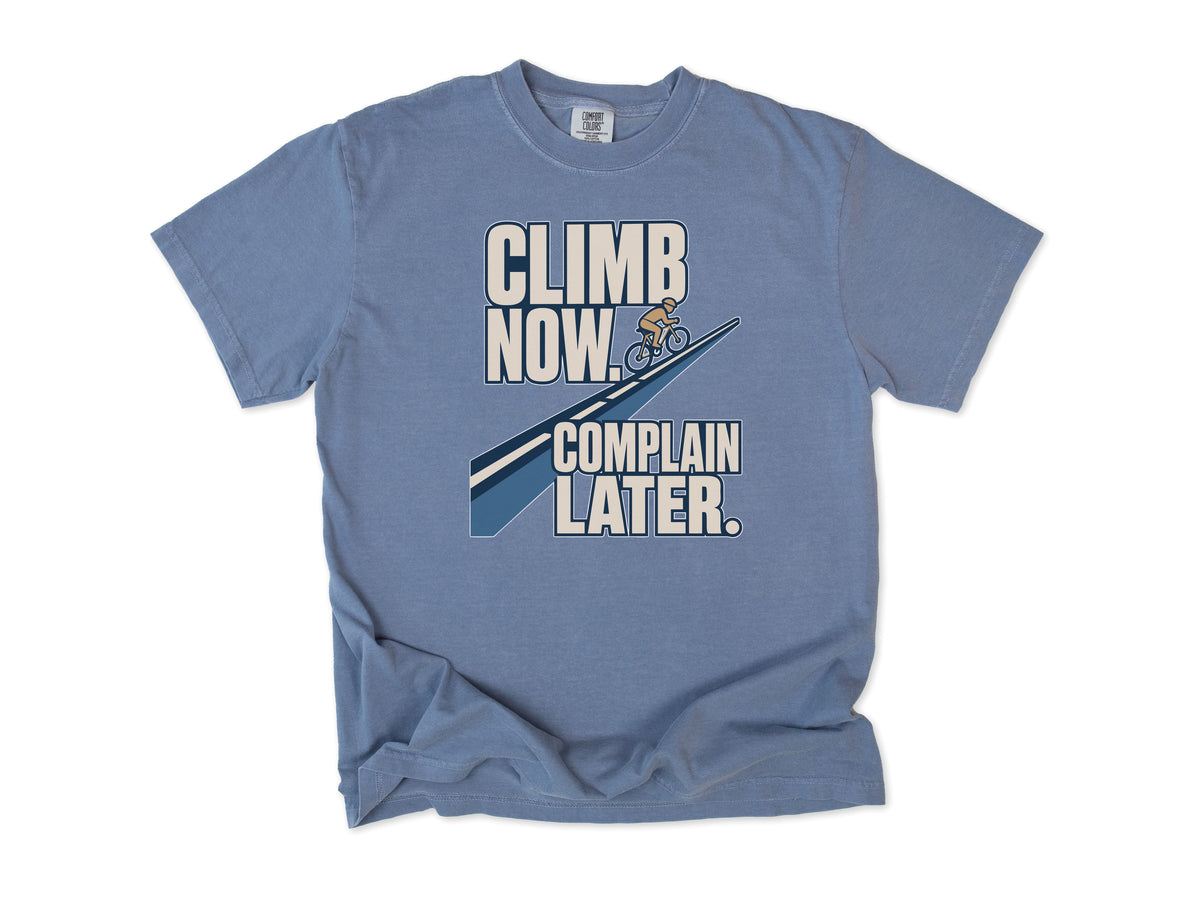 Funny cycling T-shirt in Blue Jean, 'Climb Now, Complain Later' with a cyclist on a hill, for climbers