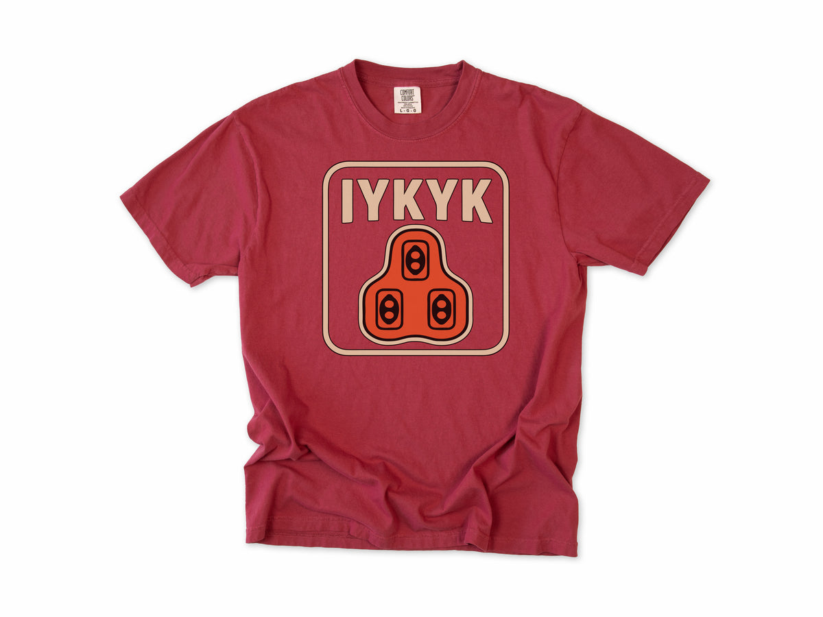 Funny cycling T-shirt in Chili, 'IYKYK' with an orange road bike cleat, for riders who use clipless pedals