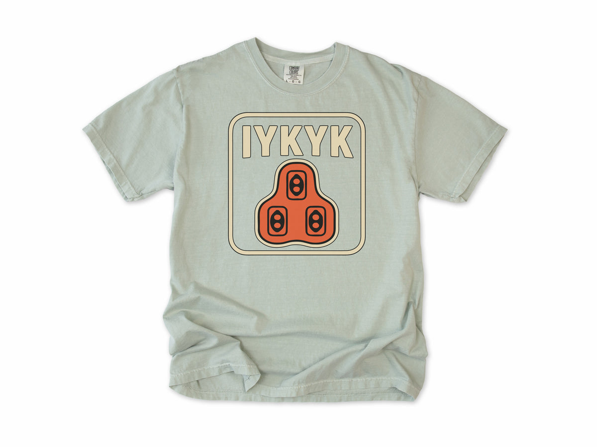 Funny cycling T-shirt in Bay, 'IYKYK' with an orange road bike cleat, for riders who use clipless pedals