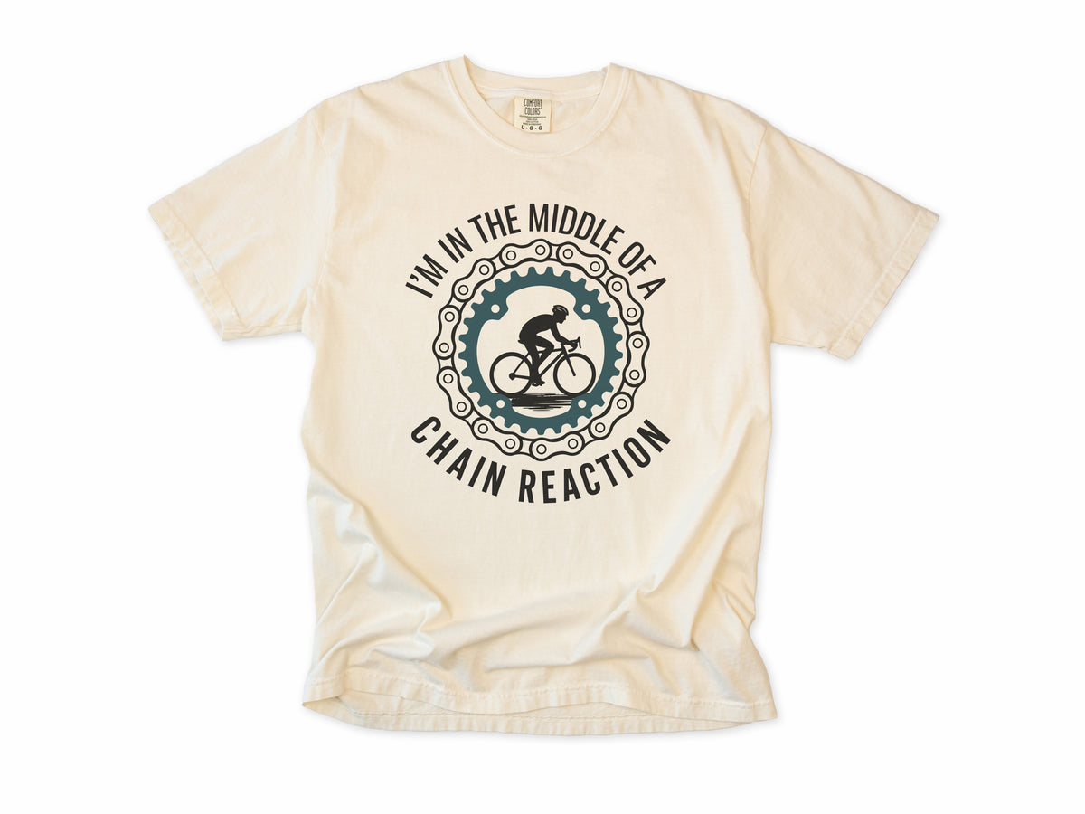 Funny cycling T-shirt in Ivory, 'I'm in the middle of a chain reaction', a cyclist in a chainring, for road cyclists