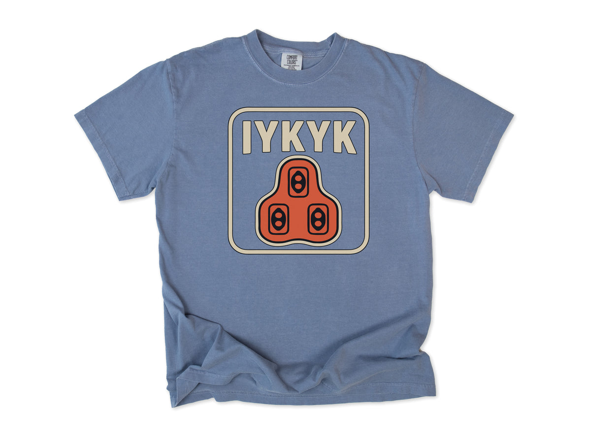 Funny cycling T-shirt in Blue Jean, 'IYKYK' with an orange road bike cleat, for riders who use clipless pedals