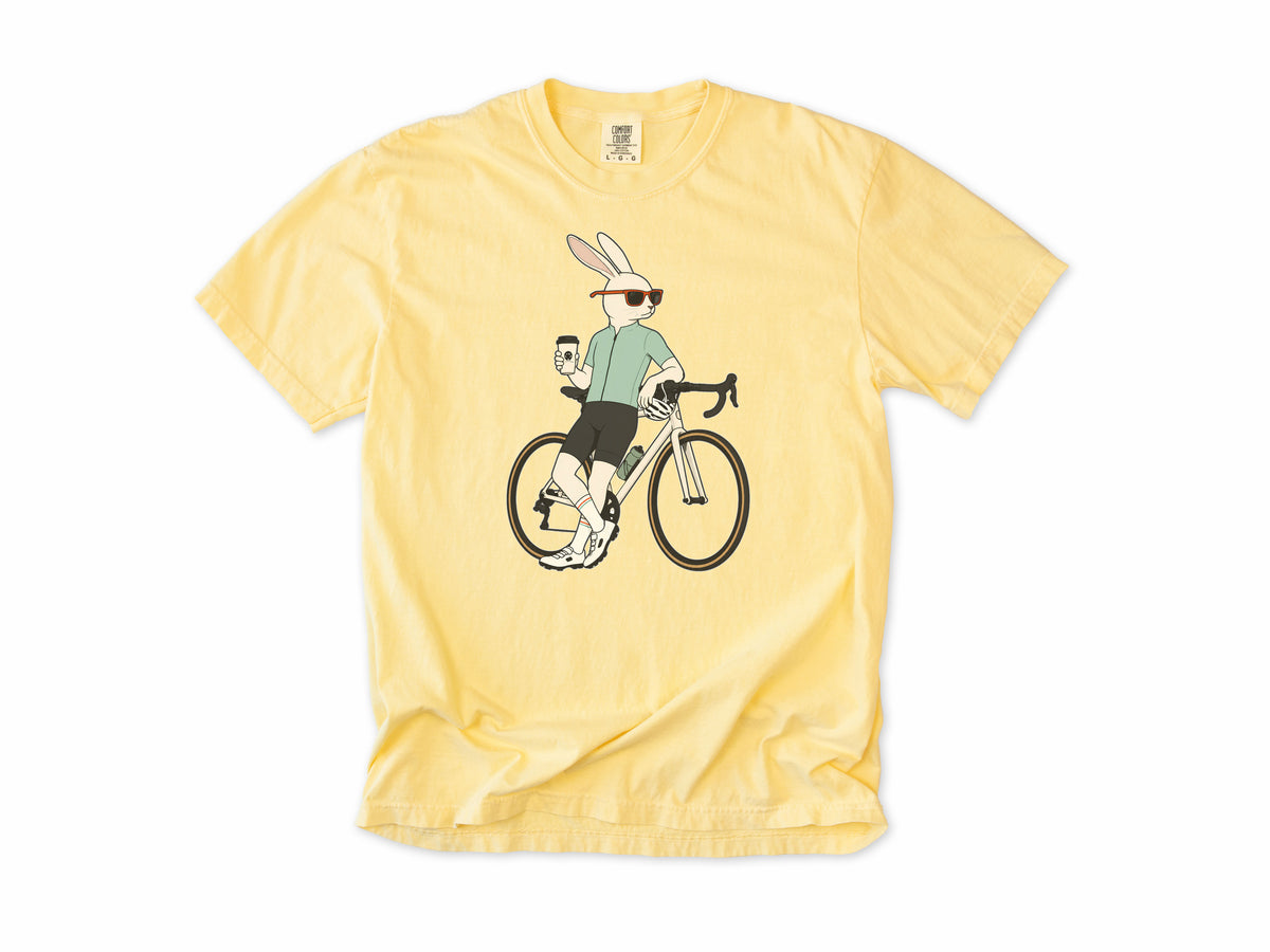 Cycling T-shirt in Butter, a hare in sunglasses with a coffee, leaning on a road bike, for coffee-loving road cyclists