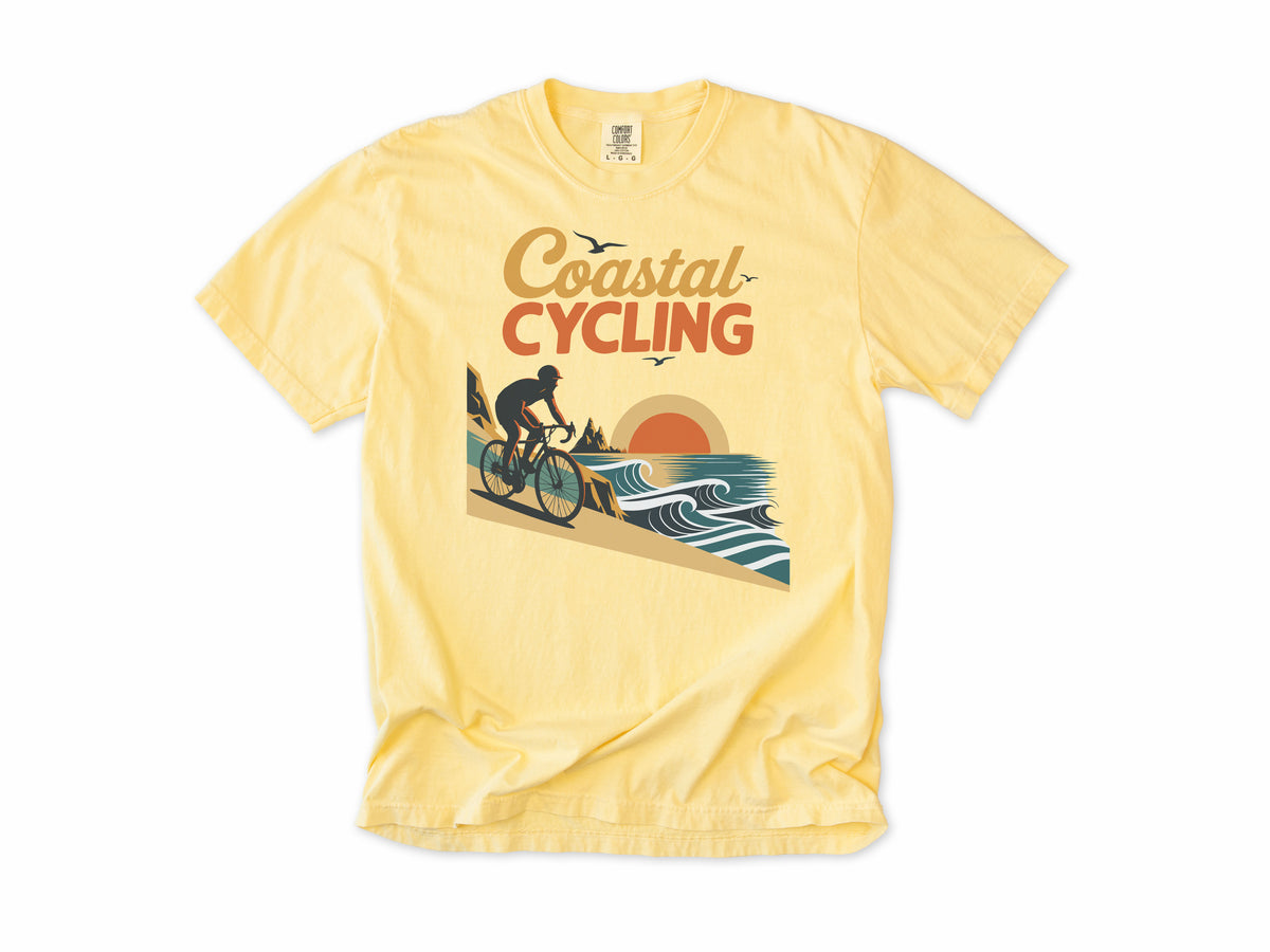 Cycling T-shirt in Butter, 'Coastal Cycling', a cyclist by the sea at sunset, for cyclists who ride the coast