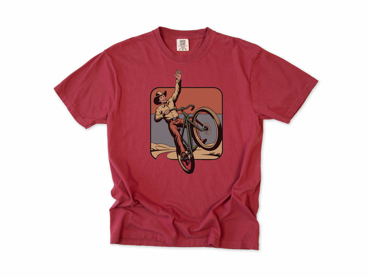 Cycling T-shirt in Chili, Cycling Cowboy: a cowboy doing a wheelie on a bike, in a desert square, for mountain bikers