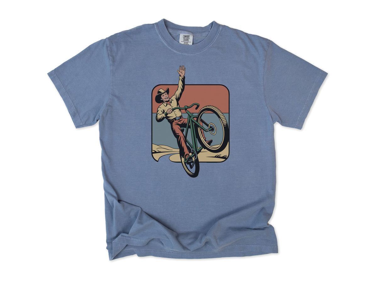 Cycling T-shirt in Blue Jean, Cycling Cowboy: a cowboy doing a wheelie on a bike, in a desert square, for mountain bikers