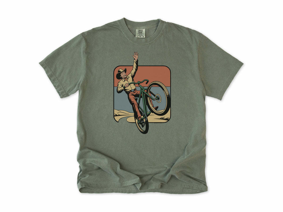 Cycling T-shirt in Moss, Cycling Cowboy: a cowboy doing a wheelie on a bike, in a desert square, for mountain bikers