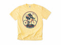 Cycling T-shirt in Butter, a bald eagle in stars and stripes riding a bike, America 250 and 4th of July gift for cyclists