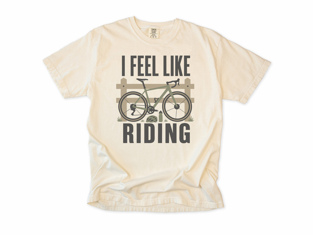 Cycling T-shirt in Ivory, 'I Feel Like Riding' with a bike on a wooden fence, for road and gravel cyclists