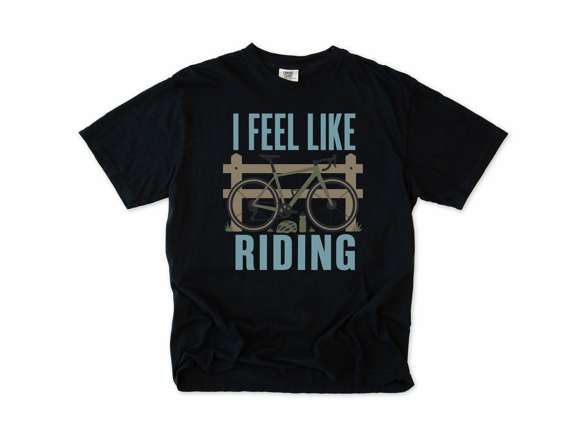 Cycling T-shirt in Black, 'I Feel Like Riding' with a bike on a wooden fence, for road and gravel cyclists